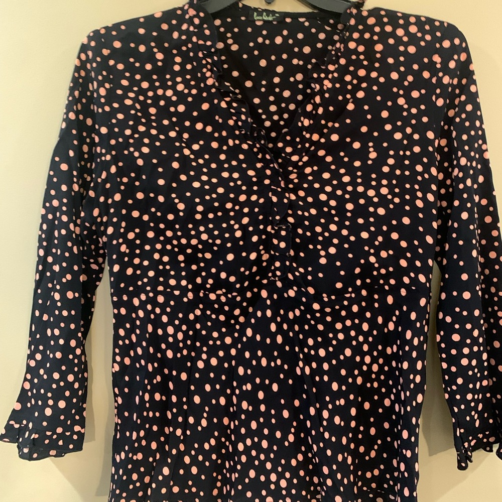 Black with Pink polka dot blouse with ruffled edges.